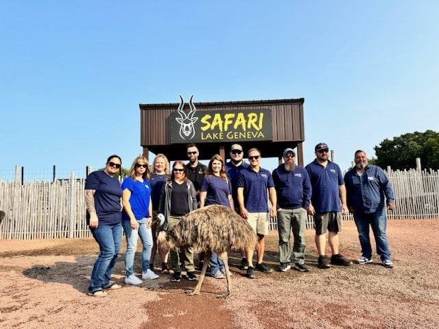 group standing in front of sign.