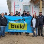 employees in front of habitat for humanity house