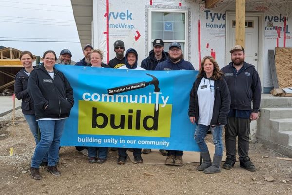 employees in front of habitat for humanity house